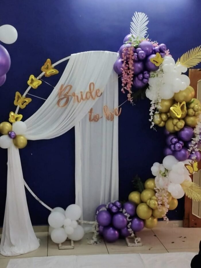 WhatsApp Image 2026-01-21 at 2.13.01 PM (2) Bride-to-Be Ring Arch Decoration | Purple, White & Gold Balloon Setup with Floral Drapes & Butterflies - Image 1